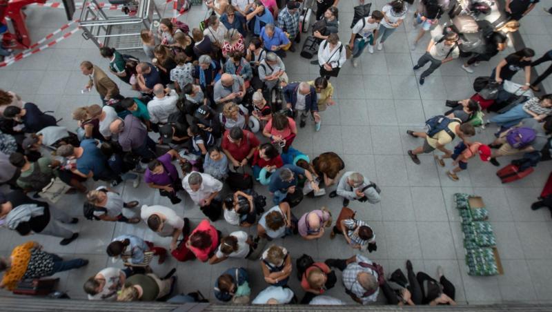 Fluggäste stehen im Terminal 2 des Münchner Flughafens unter einer Anzeigetafel. Foto: Peter Kneffel Fluggäste stehen im Terminal 2 des Münchner Flughafens unter einer Anzeigetafel. Foto: Peter Kneffel