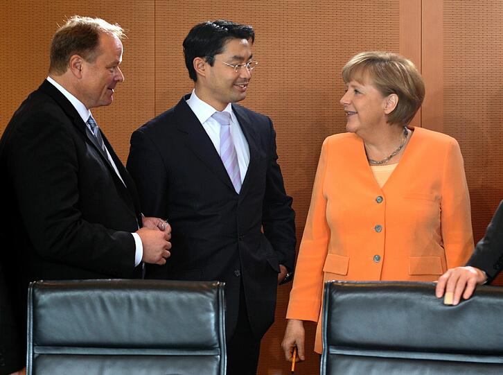 Hat da jemand morgens vor dem Kleiderschrank nicht nachgedacht: Am Mittwoch spielt Deutschland gegen Oranje - und die deutsche Bundeskanzlerin Angela Merkel trägt bei der Kabinettssitzung in Berlin Orange.