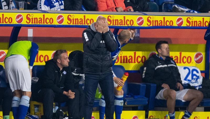Duisburgs Trainer Torsten Lieberknecht steht beim Spiel gegen Bielefeld an der Trainerbank und schlägt die Hände vor das Gesicht.