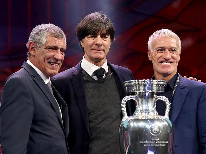 Die Trainer der ausgelosten Mannschaften der Gruppe F stehen neben dem EM-Pokal: Joachim Löw in der Mitte. Foto: Christian Charisius/dpa