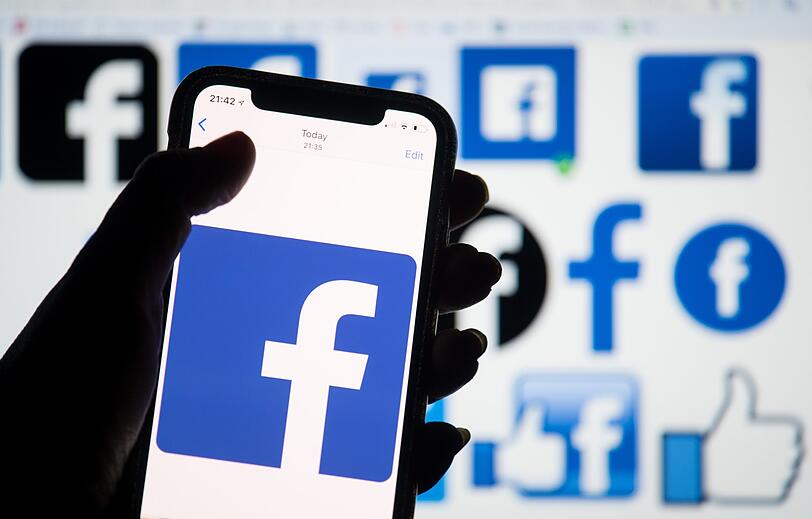 Das Logo von Facebook ist auf dem Display eines Smartphones zu sehen.