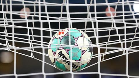 Ein Fußball liegt vor der Partie im Netz.