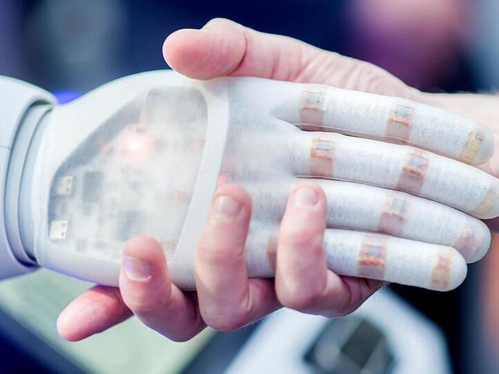 Handschlag mit einem bionischen Roboter. 42 Staaten haben sich auf erste Grundsätze für den Umgang mit künstlicher Intelligenz verständigt.