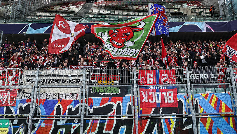 Mit ihren umgedrehten Bannern kritisieren Fans von RB Leipzig im Fan-Block die Kontrollen in Warschau.