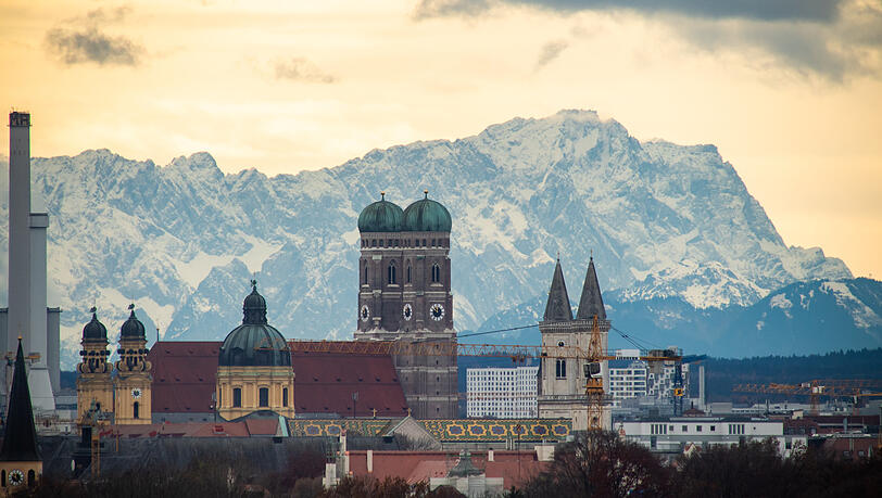 Münchens Skyline mit den Alpen im Hintergrund - einer der Glücksfaktoren in der Stadt. Diesen Sonntag ist Internationaler Tag des Glücks.