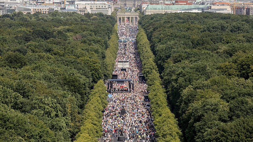 Dicht gedrängt und ohne die Abstandsregeln zu beachten stehen Tausende Menschen bei einer Kundgebung gegen die Corona-Beschränkungen auf der Straße des 17. Juni in Berlin.