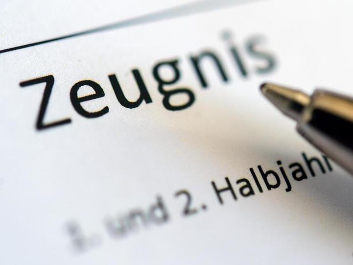 Ein Kugelschreiber auf einem Zeugnis. Foto: Sebastian Gollnow/dpa/Archivbild