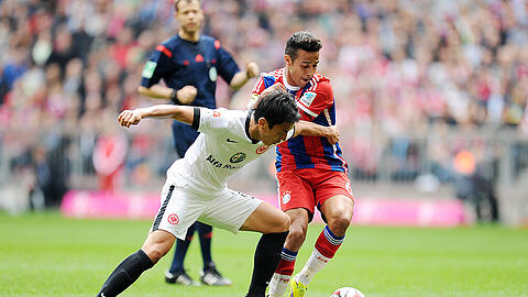 FC Bayern gegen Eintracht Frankfurt: Szene aus dem Bundesligaspiel am 11. April 2015. Im Bild: Bayerns Thiago (r.) und der Frankfurter Maskoto Hasebe.
