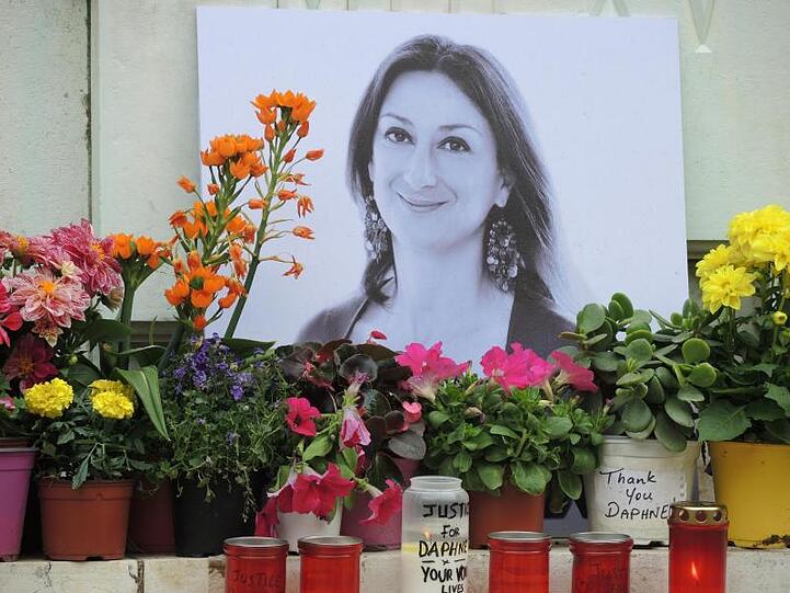 Am Fuß eines Denkmals vor dem Justizpalast erinnert ein Foto an die ermordete maltesische Journalistin Daphne Caruana Galizia.
