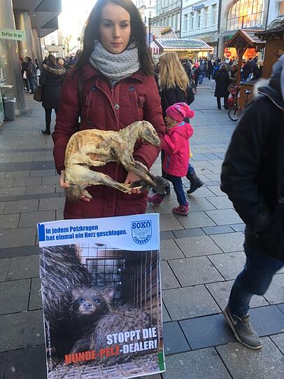 Protest der &bdquo;Soko Tierschutz&ldquo; in der Fußgängerzone. Das Bild auf dem Plakat zeigt einen Marderhund.