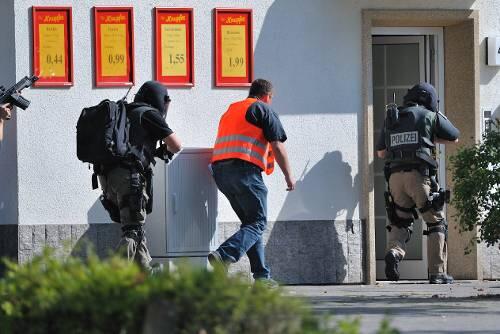 Beamte stürmen das haus, in dem sich der Bombenleger verschanzt hat.