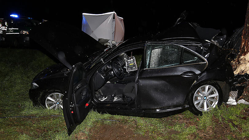 Schreckliche Bilder aus Icking: Der BMW kam von der Straße ab und prallte gegen einen Baum. Zwei 19-jährige Männer starben.