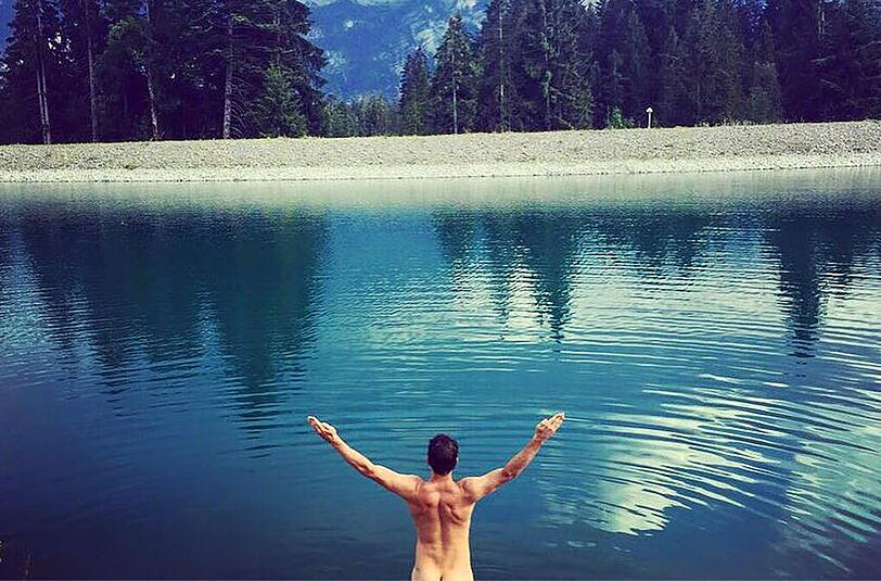 Der Sportler Felix Neureuther zeigt sich vor einem Bergsee von seiner besten Seite. Besonders lustig ist seine doppeldeutige Bildunterschrift "Free Willy!&ldquo; bei Facebook.