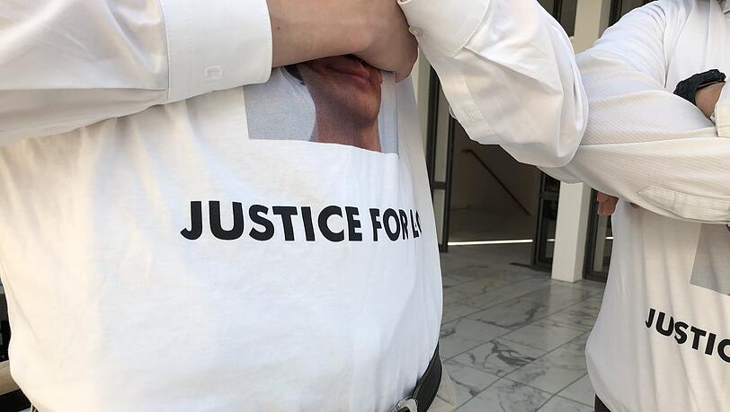 Zwei junge Männer tragen kurz vor dem Start eines weiteren Verhandlungstages im Prozess um den Tod eines 13-Jährigen bei einem Ruderunfall T-Shirts, mit denen sie ihre Unterstützung für den toten Jungen ausdrücken sollen. Zwei junge Männer tragen kurz vor dem Start eines weiteren Verhandlungstages im Prozess um den Tod eines 13-Jährigen bei einem Ruderunfall T-Shirts, mit denen sie ihre Unterstützung für den toten Jungen ausdrücken sollen.