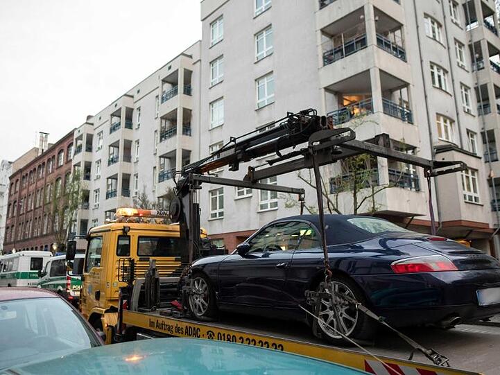 Beschlagnahmt: Ein Porsche Cabrio wird nach einem Großeinsatz im Berliner Bezirk Neukölln abtransportiert.