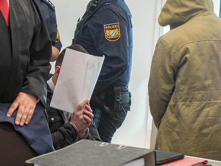 Zwei von vier Angeklagten sitzen in dem Verhandlungssaal des Amberger Amtsgerichts. Foto: Armin Weigel
