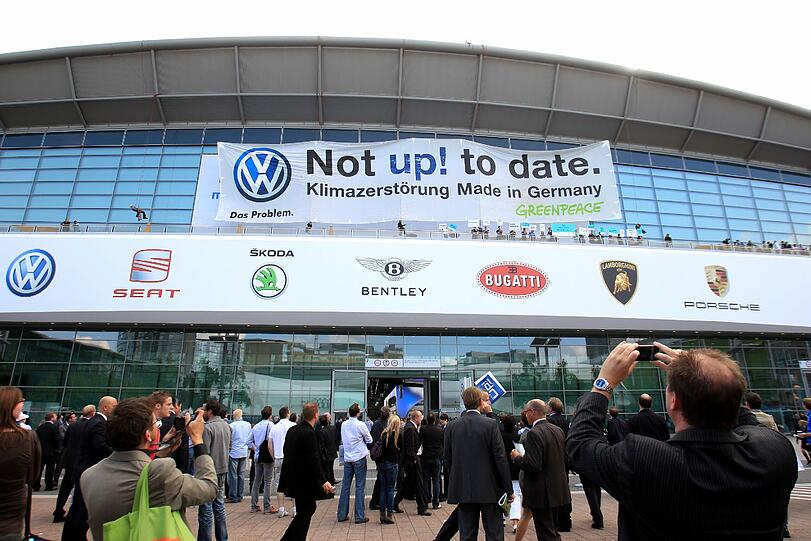 Mit Protest-Plakaten machen die Greenpeace-Aktivisten ihrem Unmut über den neuen Kleinwagen "VW Up" auf der Internationalen Automobilausstellung in Frankfurt Luft.