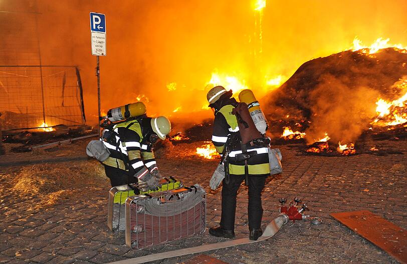 Feuer, Rauch, zerborstene Fenster - nach der Sprengung der Bombe hat die Feuerwehr viel zu tun: Umherfliegendes Stroh hatte Brände verursacht.