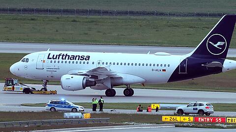 Zwei Aktivisten haben sich auf einer Zufahrt für Start- und Landebahnen am Flughafen Franz-Josef-Strauß festgeklebt.
