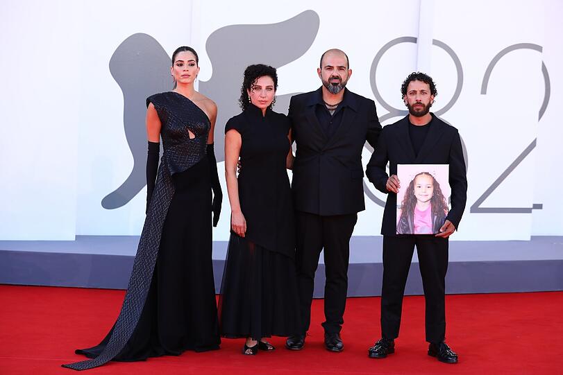 Bei der Premiere in Venedig: Saja Kilani (von li.), Clara Khoury, der israelische Schauspieler Amel Hlehel und Motaz Malhees stehen mit einem Foto des pal&auml;stinensischen M&auml;dchens Hind Rajab auf dem roten Teppich w&auml;hrend der 82. Ausgabe der Filmfestspiele von Venedig.