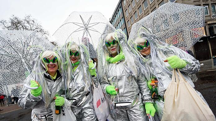 Jecken schützen sich beim traditionellem Kö-Treiben auf der Düsseldorfer Königsallee mit Schirmen vor dem Regen. Jecken schützen sich beim traditionellem Kö-Treiben auf der Düsseldorfer Königsallee mit Schirmen vor dem Regen.