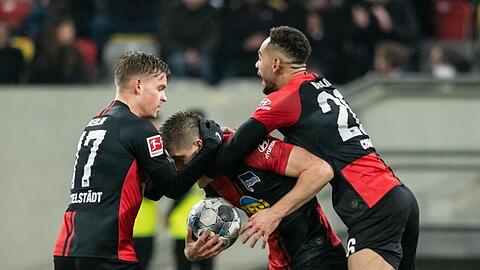 Berlins Krzysztof Piatek (M) jubelt mit Maximilian Mittelstädt (l) und Matheus Cunha über seine Treffer zum 3:3.