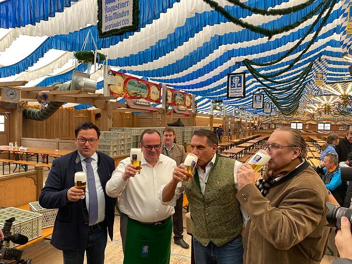 Wiesn-Chef Clemens Baumgärtner (zw. v. li.), Schausteller-Sprecher Peter Bausch, Festhallen-Wirt Peter Schöniger und Schausteller Robert Eckl (v. li.) gönnen sich ein Bier nach dem Probe-Fassanstich vor dem Münchner Frühlingsfest.