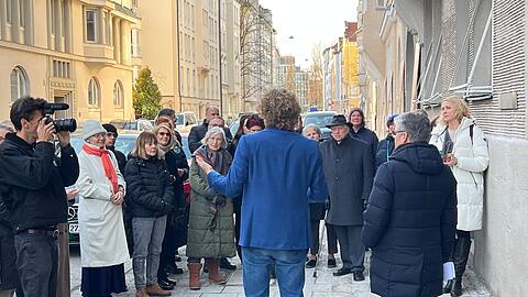Matthias Georgi (im blauen Jackett) spricht zu den G&auml;sten der Zeremonie in der Ohmstra&szlig;e &ndash; rechts neben ihm Stadtrat Winfried Kaum (CSU) als Vertreter des Oberb&uuml;rgermeisters.