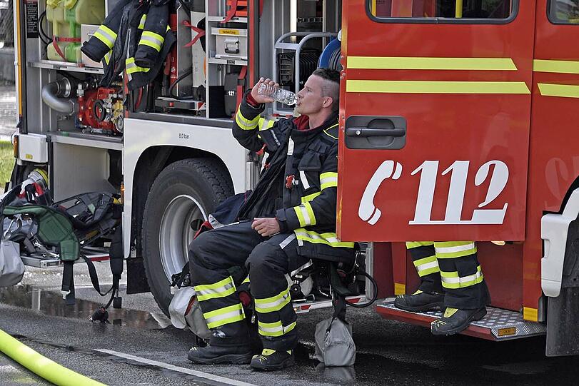 Ein Feuerwehrmann gönnt sich eine Pause von den Löscharbeiten.
