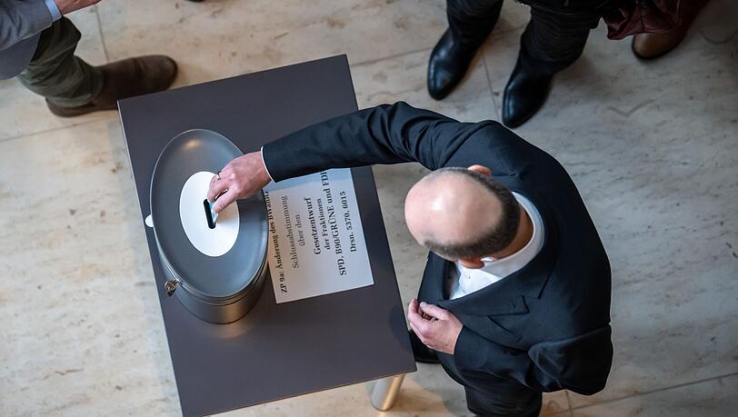 Bundeskanzler Olaf Scholz bei der Stimmabgabe im Rahmen der namentlichen Abstimmung im Bundestag.