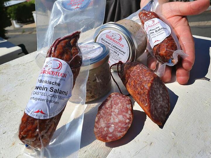 Günther Schlegel präsentiert verschiedene seiner Wurstprodukte, die mit Frankenwein hergestellt wurden. Foto: Karl-Josef Hildenbrand/dpa/Archivbild