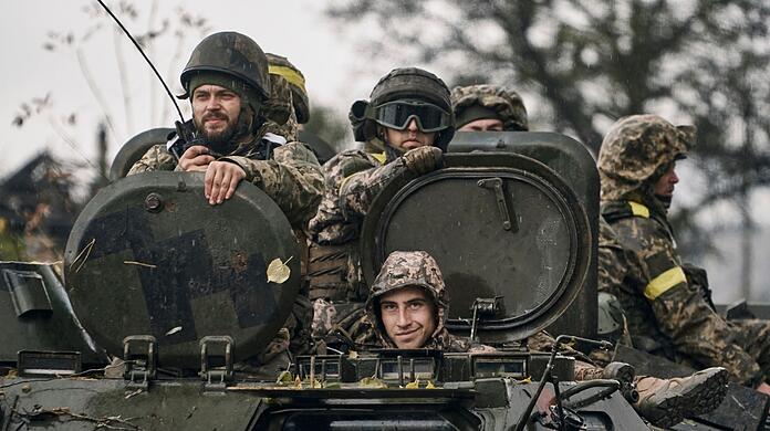Ukrainische Soldaten fahren in der Region Donezk auf einem Schützenpanzer.