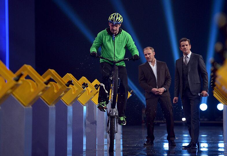 Daniel Rall bei seiner spektakulären Wette. Mit den Speichen seines Fahrrads öffnete er Bierflaschen. Foto: Patrick Seeger/ZDF