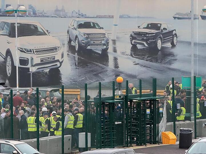 Mitarbeiter versammeln sich vor einem Jaguar Land Rover Standort in der Nähe von Liverpool. Der Automobilhersteller wird weltweit rund 4500 Stellen streichen.