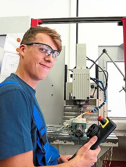 Stephan Bock (18) vor einer Fräsmaschine.