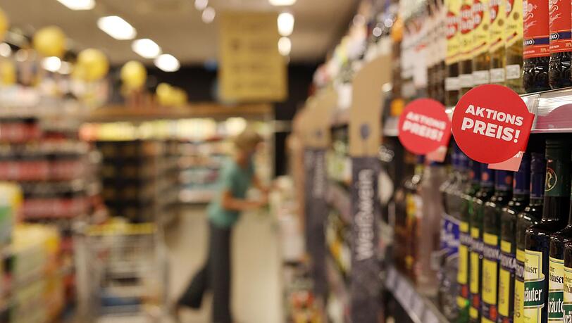 In den Regalen eines Discounters sind Plakate mit der Aufschrift "Aktion Preis!" zu sehen.