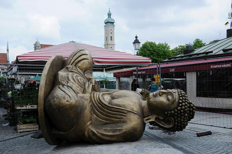 Die Münchner Buddhisten nehmen weiter massiv Anstoß an dem liegenden Buddha vom Viktualienmarkt.