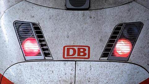 Rote Rücklichter leuchten am Triebwagen eines ICE-Zuges der Deutschen Bahn.