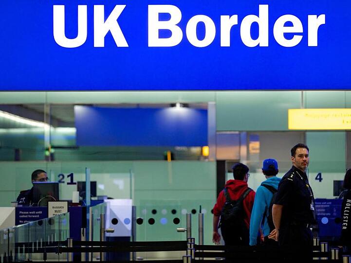 Noch ist das Reisen einfach: Grenzbeamte am Londoner Flughafen Heathrow unter einem Grenzschild.
