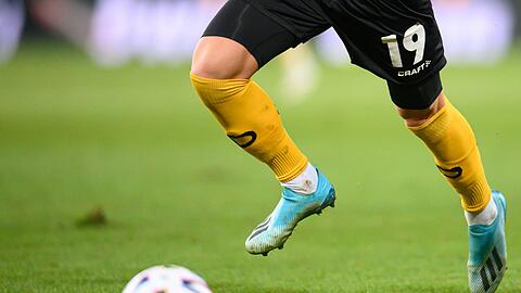 Ein Fußballspieler spielt den Ball.
