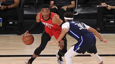 Russell Westbrook (l) von den Houston Rockets dribbelt gegen Seth Curry (r) von den Dallas Mavericks.