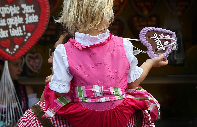 Eine junge Wiesn-Besucherin mit einem Lebkuchenherz.