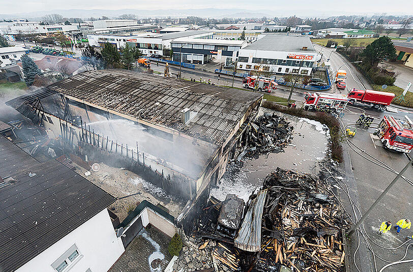 Bilder vom Morgen nach dem Brand: Einsatzkräfte der Feuerwehr an den Überresten der Lagerhalle.