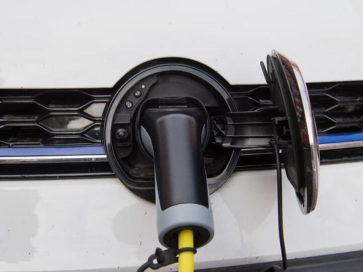 Ein Elektroauto wird an einer E-Ladestation aufgeladen.