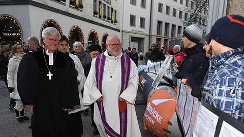 Der Vorsitzende der Deutschen Bischofskonferenz Reinhard Kardinal Marx (M) geht an einer Mahnwache. Foto: Felix Hörhager/dpa/Archivbild