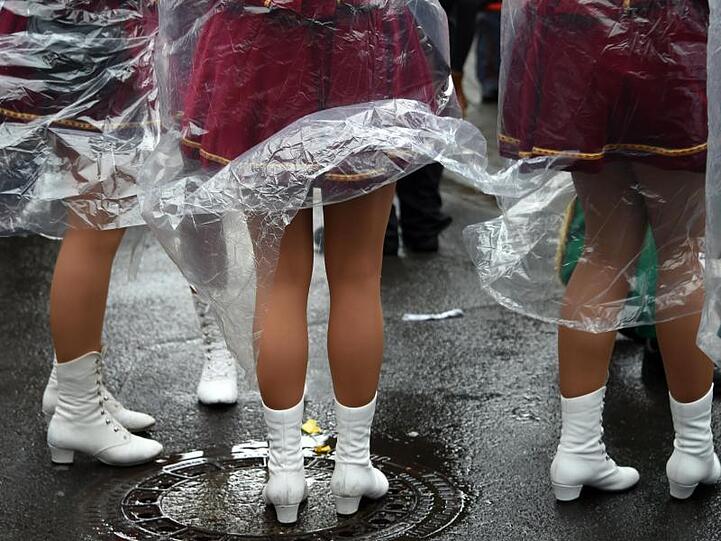 Mit Plastik-Umhänge gegen den Regen: Tief "Bennet" geht den Karnevalisten etwas auf die Nerven.