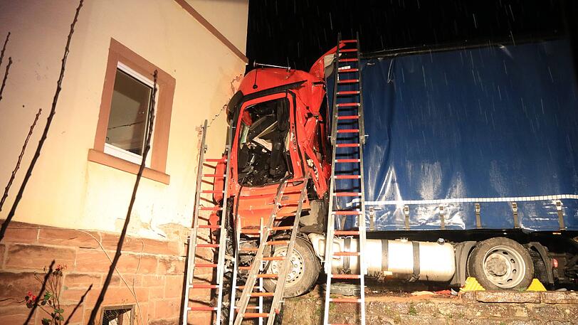 Der Sattelzug rammte ein geparktes Auto und donnerte gegen ein Haus. Die Rettung des Fahrers gestaltete sich extrem kompliziert.
