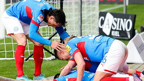 Kiels Fabian Reese (l-r), Steven Skrzybski und Aron Holbert Fridjonsson bejubeln das 1:0.