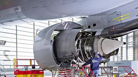 Ein Mitarbeiter arbeitet in einem Werk der MTU Aero Engines AG an einer Flugzeug-Turbine. Foto: -/MTU Aero Engines AG/dpa/Symbolbild