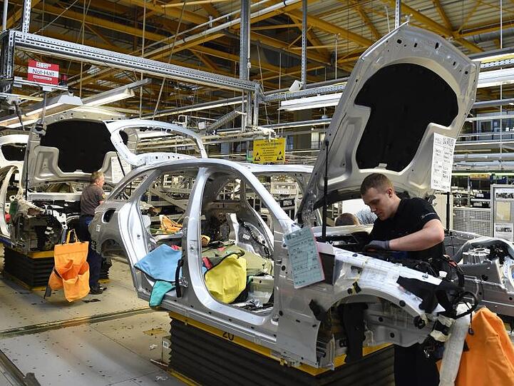 Mitarbeiter von Mercedes-Benz arbeiten im Werk in Bremen an einer Limousine der C-Klasse.